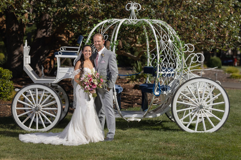 Couple with white carriage at private estate wedding