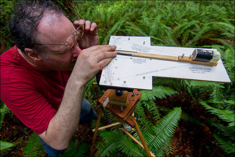 Redwood exploreer Ron Hildebrandt measuring Grogans Fault coast Redwood, McArthur creek upslope